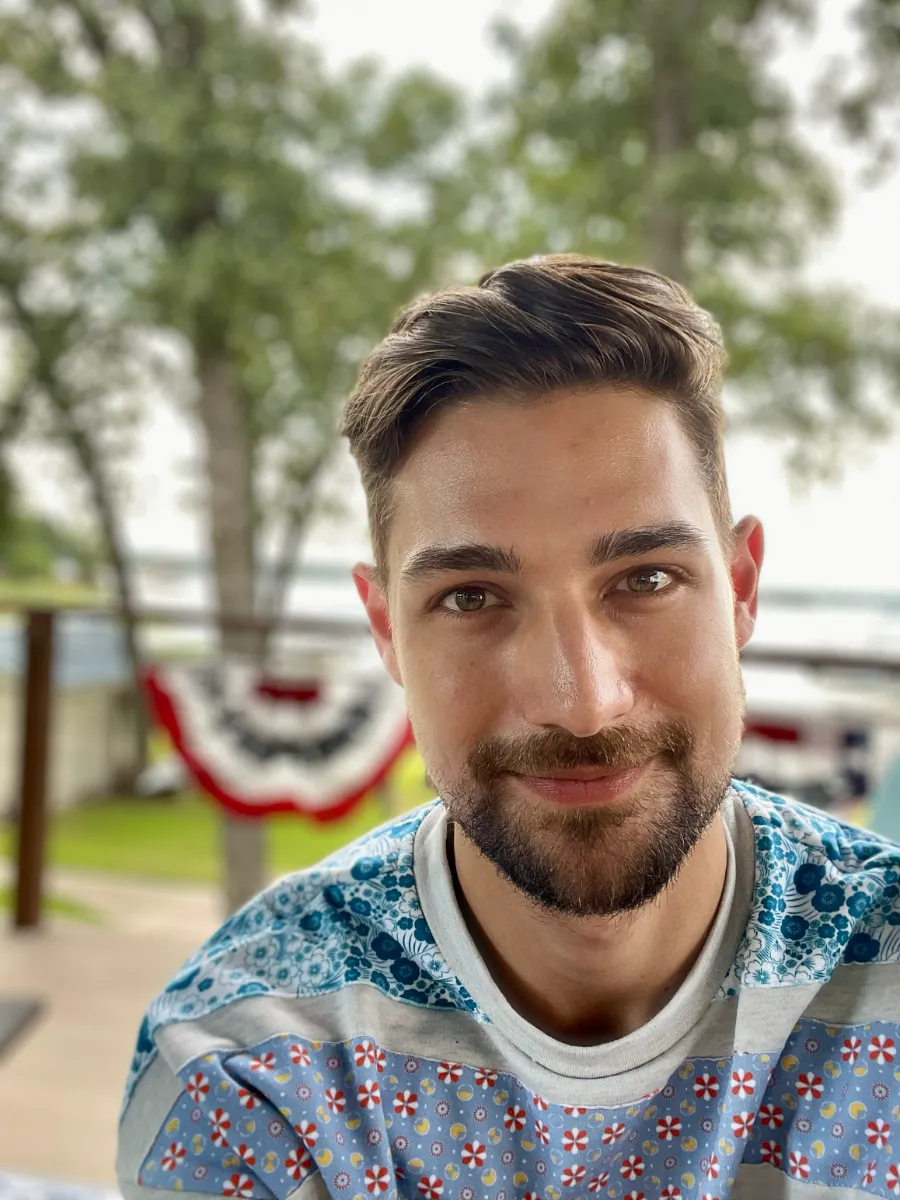 Jeremiah on porch with US flag behind him