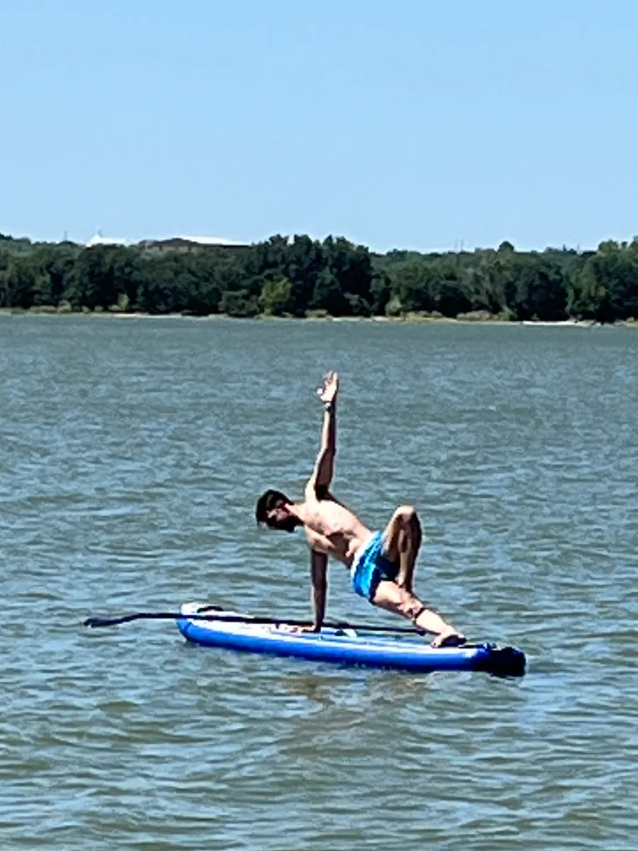 Jeremiah doing a yoga pose on a paddleboard