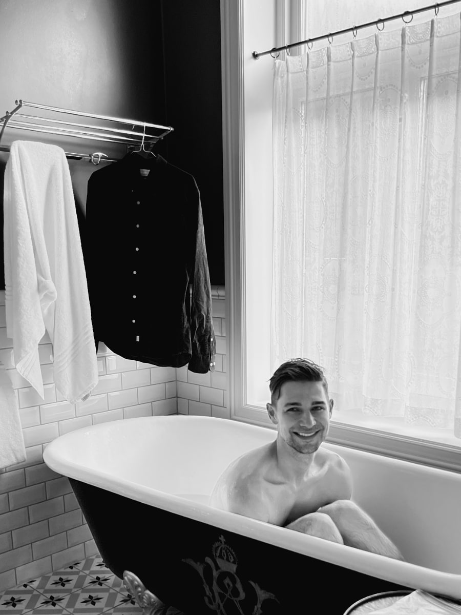 Jeremiah sitting in clawfoot bathtub