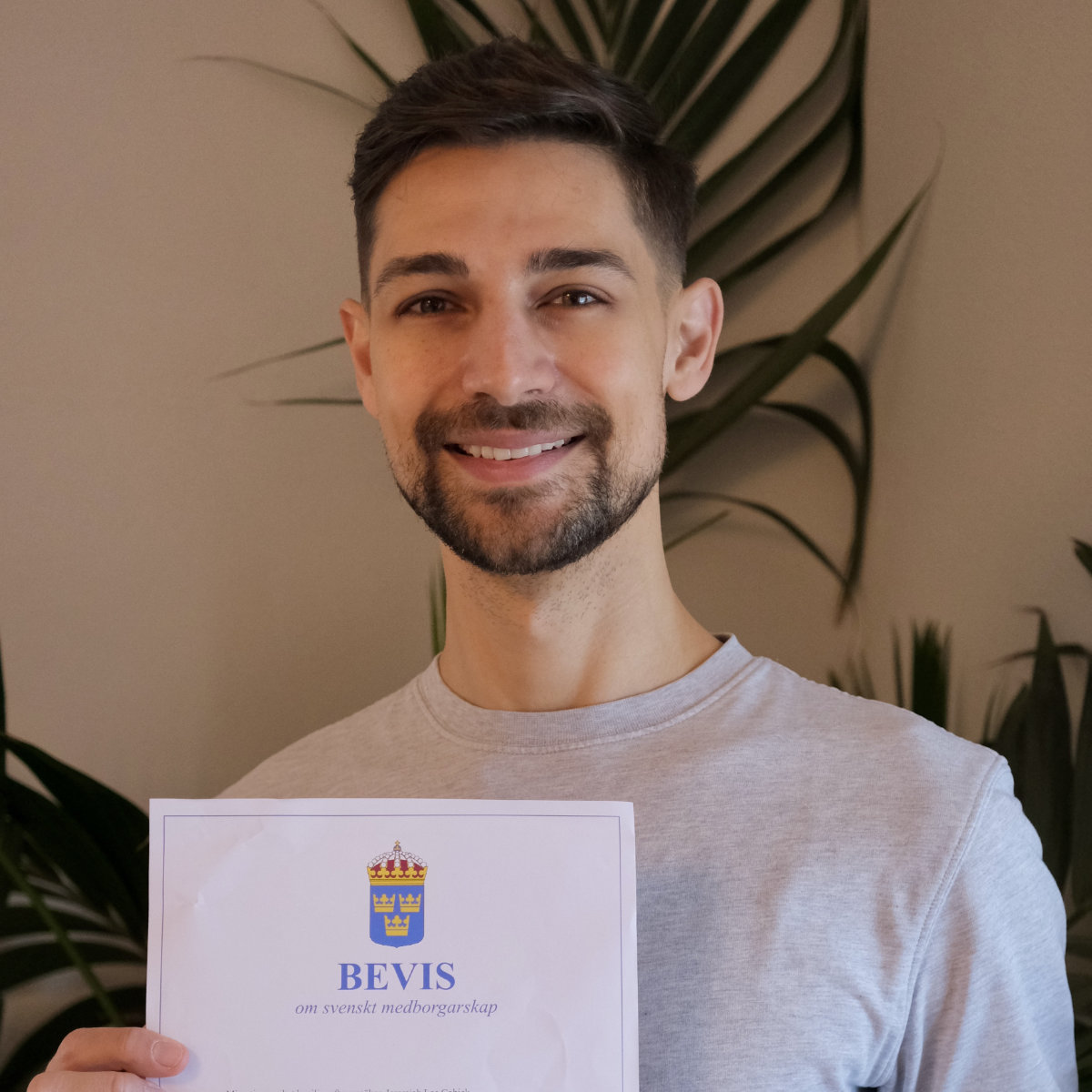 Jeremiah holding paper confirming his citizenship