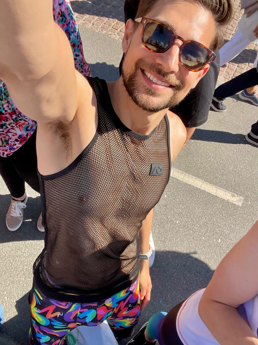 Jeremiah selfie. Wearing a black mesh tanktop and rainbow graffiti tights