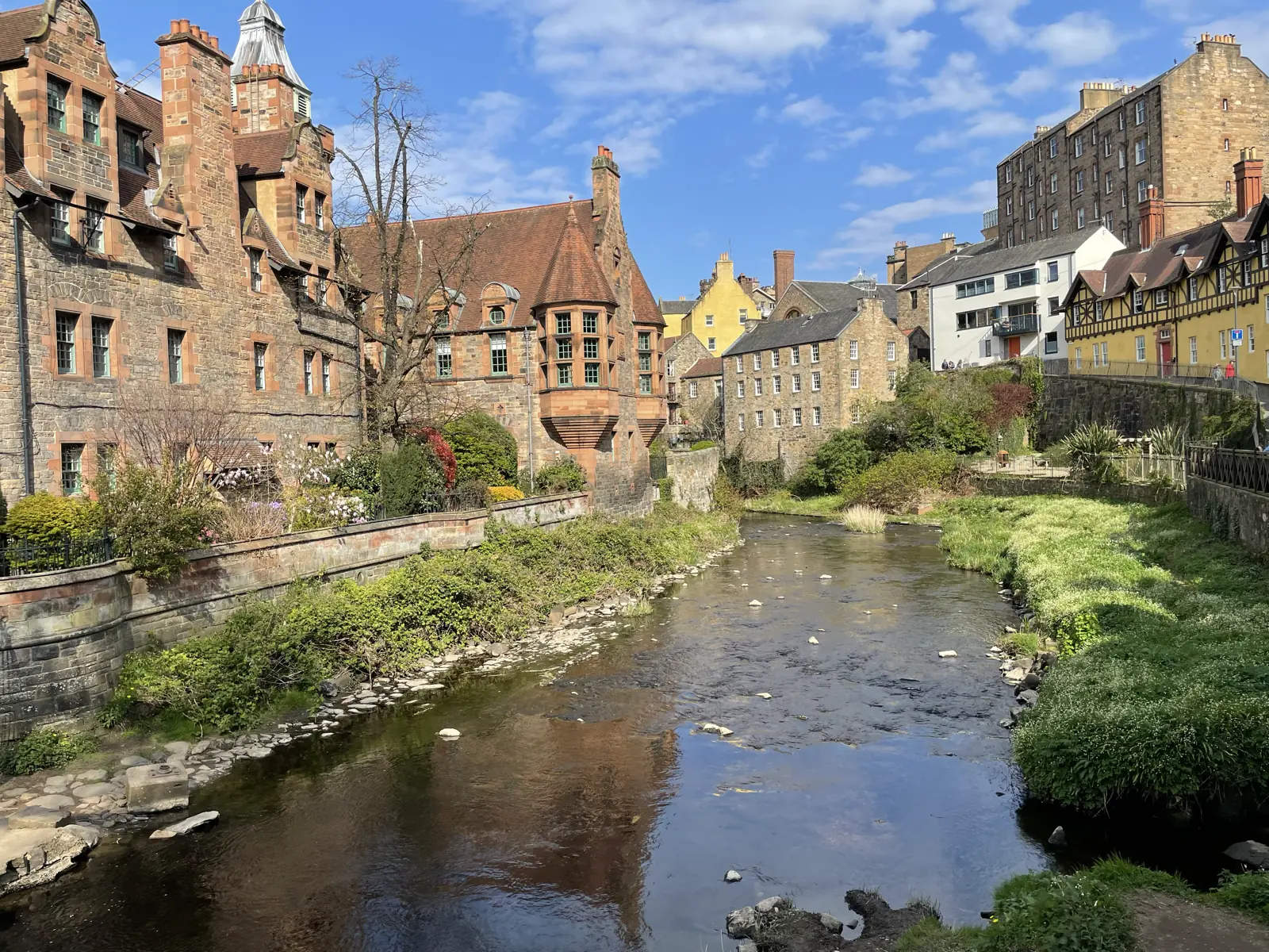 View of Edinburgh looking down a river with Edwardian architecture buildings along it