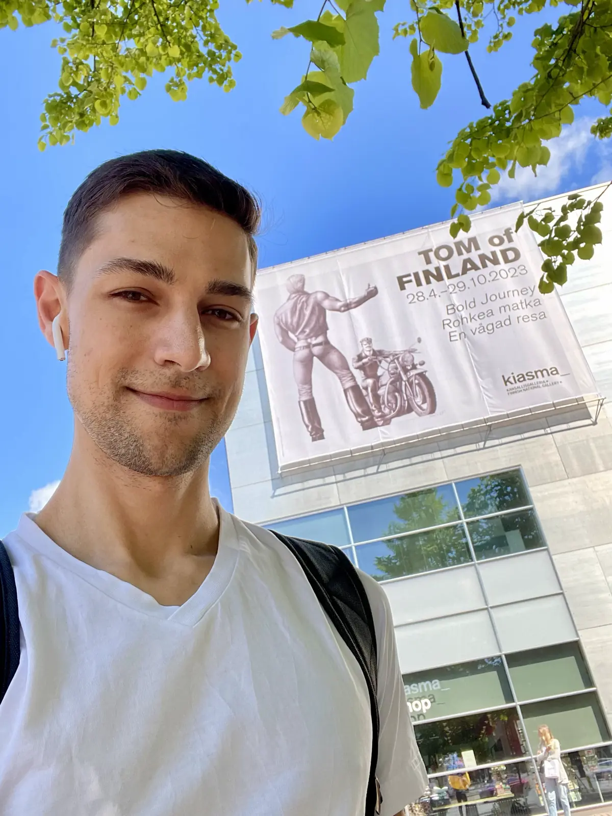 Jeremiah in front of the Tom of Finland exhibit sign on the museum