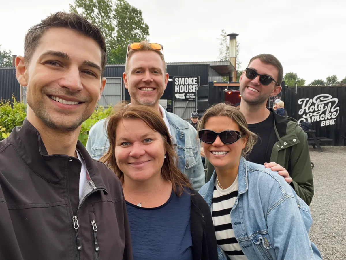 Jeremiah, Karin, Arthur, Vendela, and Wes smiling outside of Holy Smoke BBQ