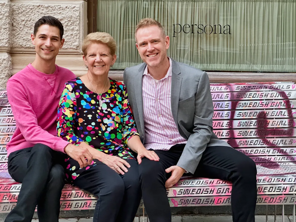 Jeremiah, Gay, Arthur sitting on graffitied bench that says Swedish girls in front of restaurant Persona